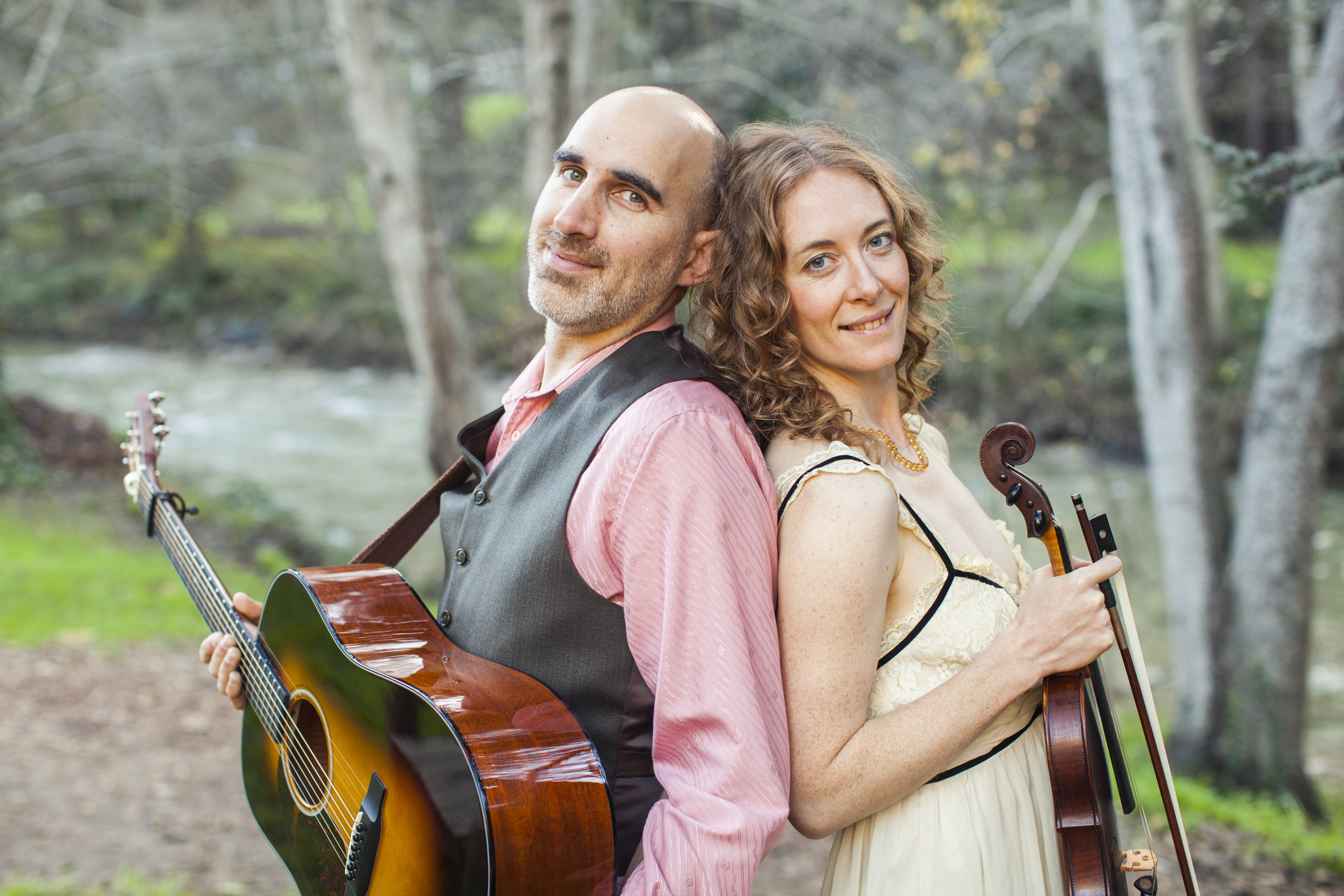 Dan Frechette & Laurel Thomsen posing with their violin and guitar