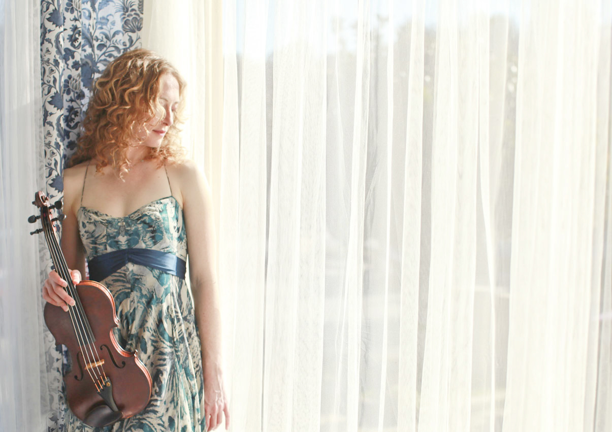 Violinist Laurel Thomsen infront of a window