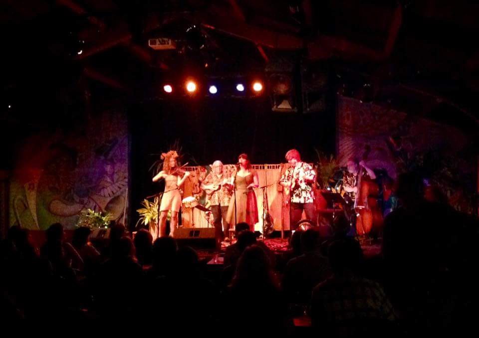 Laurel Thomsen performing on stage with a band