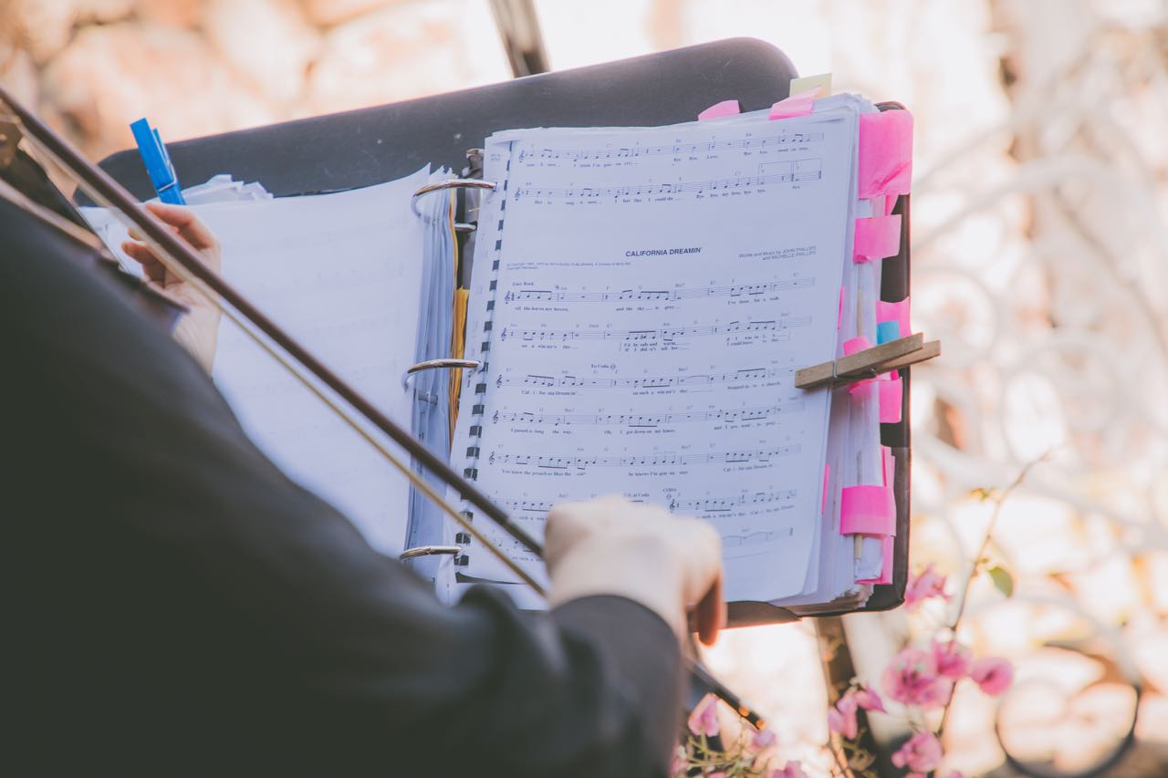 Violinist Laurel Thomsen reading sheet music at a wedding